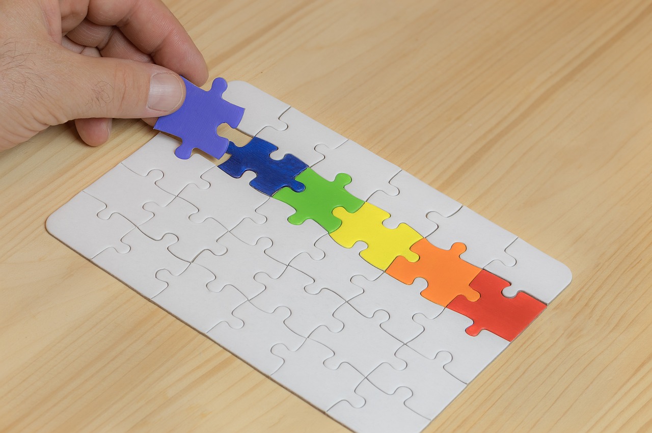 Wooden puzzle pieces spread across a table