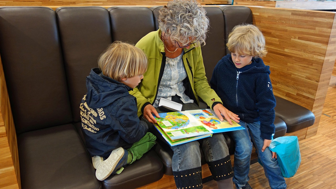 A child reading aloud from a book at a table