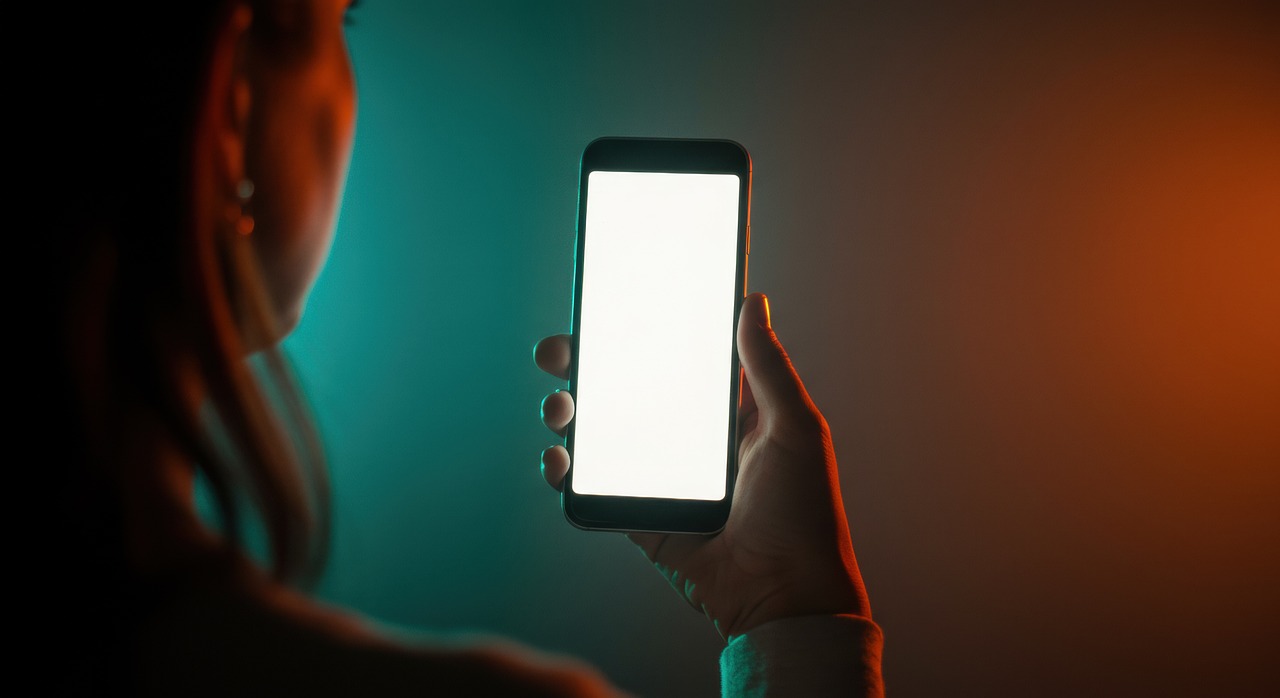 A phone glowing in a dark room