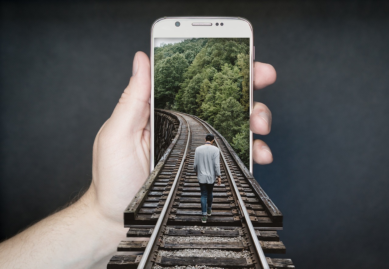 A pair of hands holding a smartphone, scrolling a settings screen